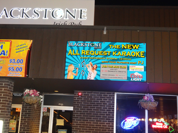 View of the front door, windows and overhanging specials at the Blackstone Irish Pub